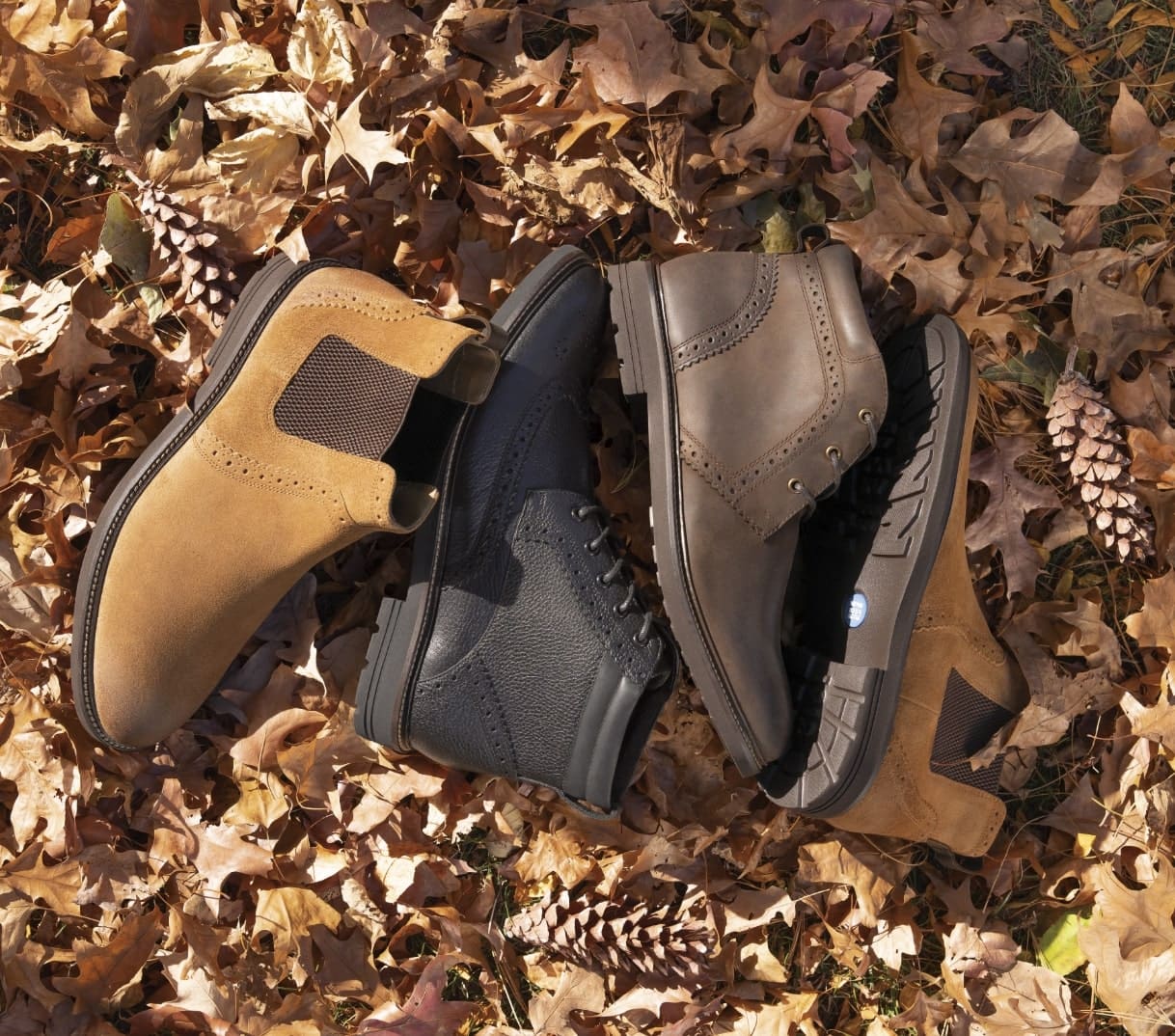 Shop Nunn Bush boots featuring the O II Series in a pile of leaves. 