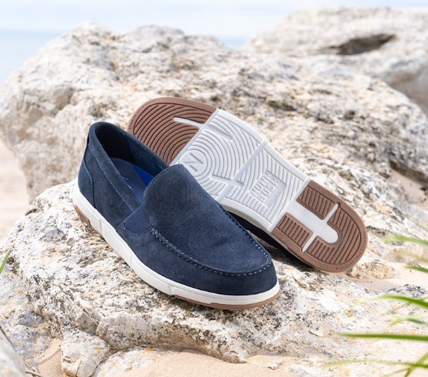 Image features the Luca in navy suede on a rock.