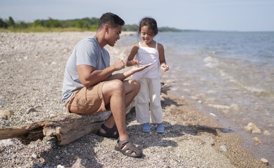 Image features the Laguna fisherman sandal on a rocky beach.