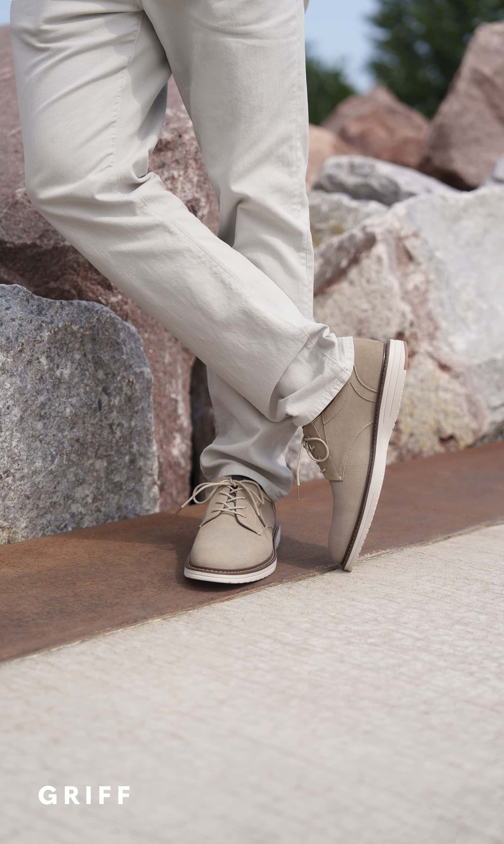 Men's Dress Shoes category. Image features the Griff suede in sand next to some rocks.