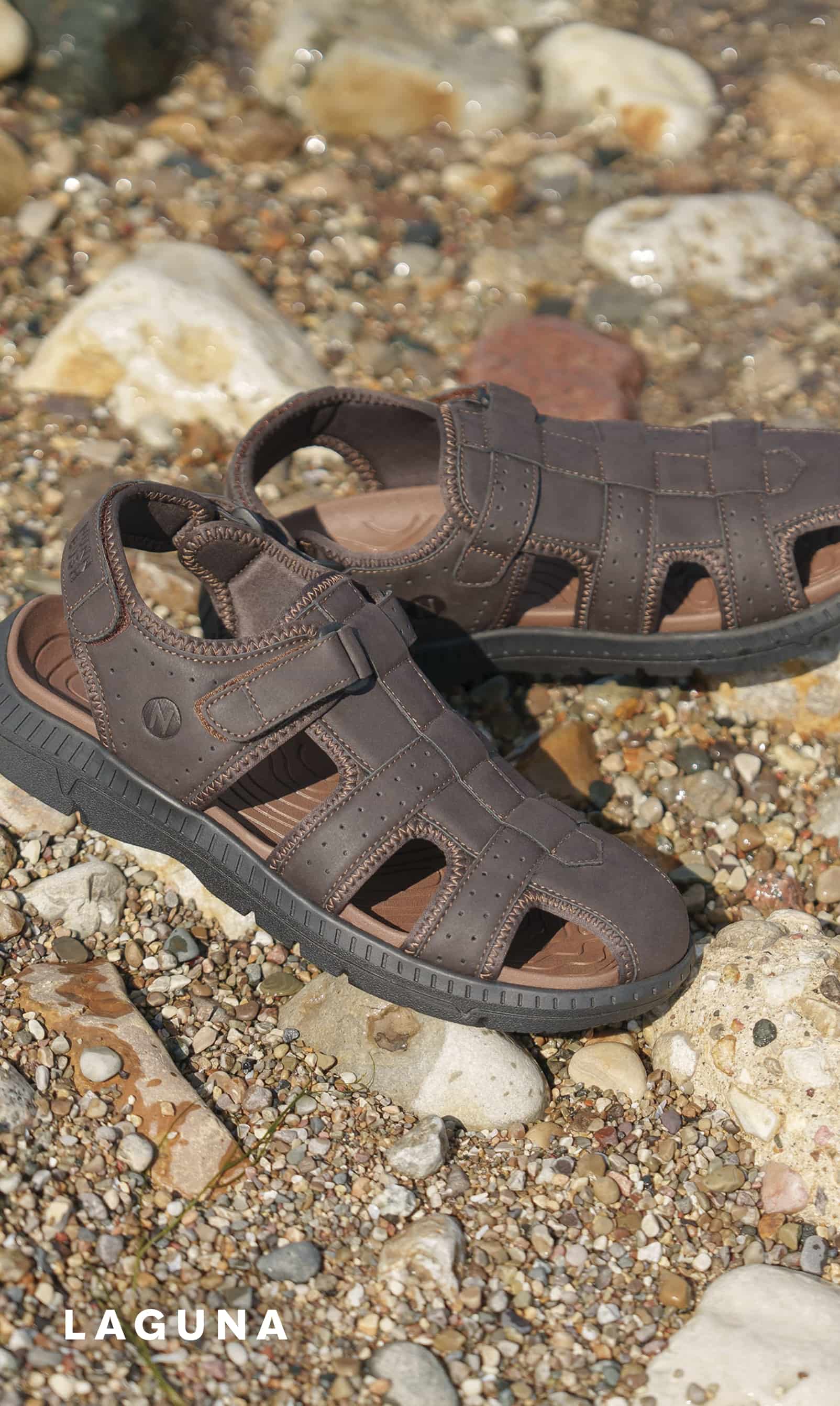 Men's Sandals category. Image features the Laguna fisherman sandal on a rocky beach.